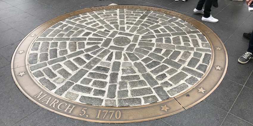 Boston Massacre site memorial marker on cobblestone circle, dated March 5, 1770.