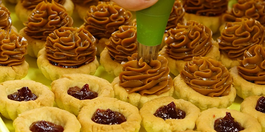 Close-up of a golden butter tart with a rich custard filling