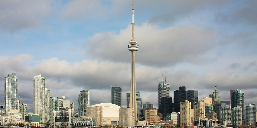 The CN Tower, a famous monument in Canada, rises above the illuminated Toronto skyline