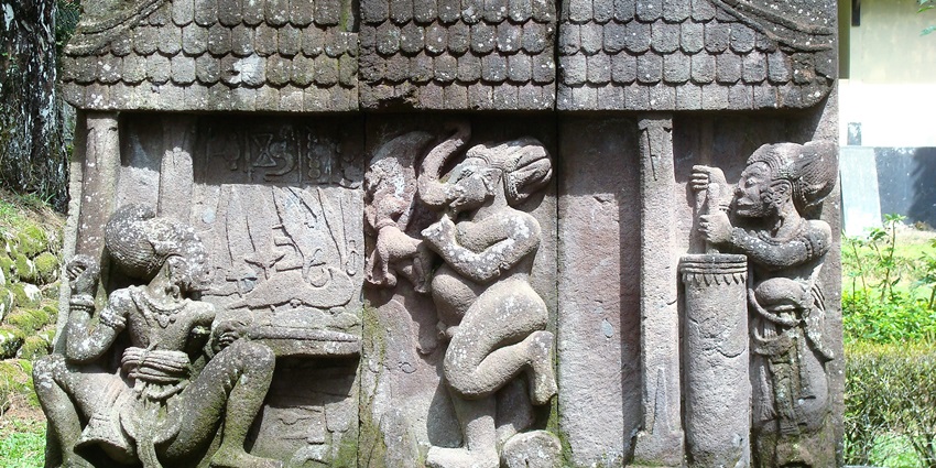 A stone relief depicting traditional scenes as part of the Sukuh Temple, one of the culturally rich monuments in Indonesia.