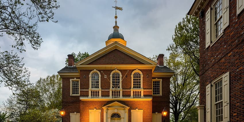 Front face of Carpenters hall with two lamps on each side, small entrance gate and windows