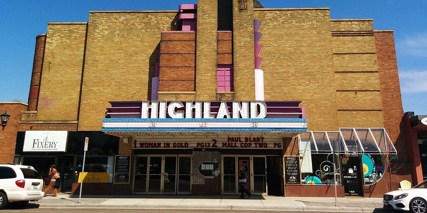 Cosy local cinema showing indie and mainstream films with a Highland-themed café and vibrant murals.
