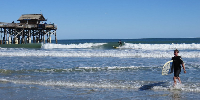 Surfing at the Cocoa Beach Pier is one of the best things to do in Florida for Spring Break.
