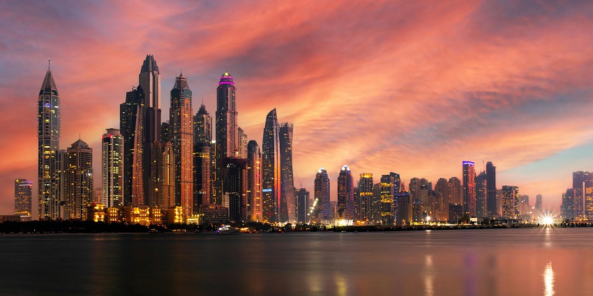 Perfect sunset viewing point with reflective waters and panoramic city skyline.