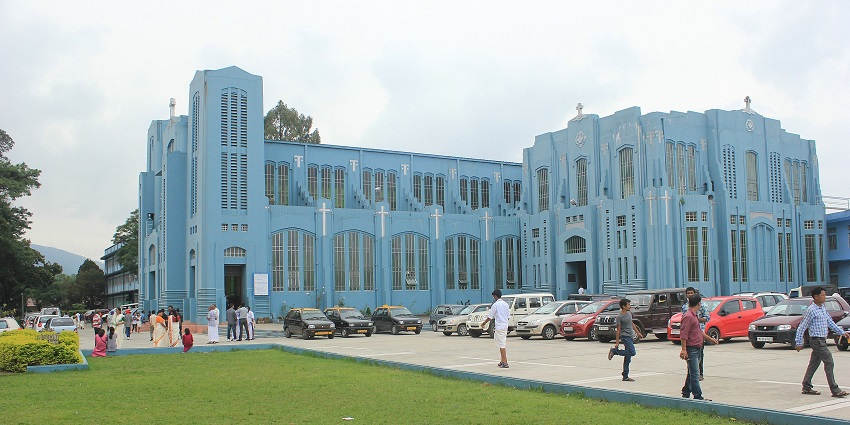 Cathedral of Mary help of Christians with its blue architectural building and multiple cars parked