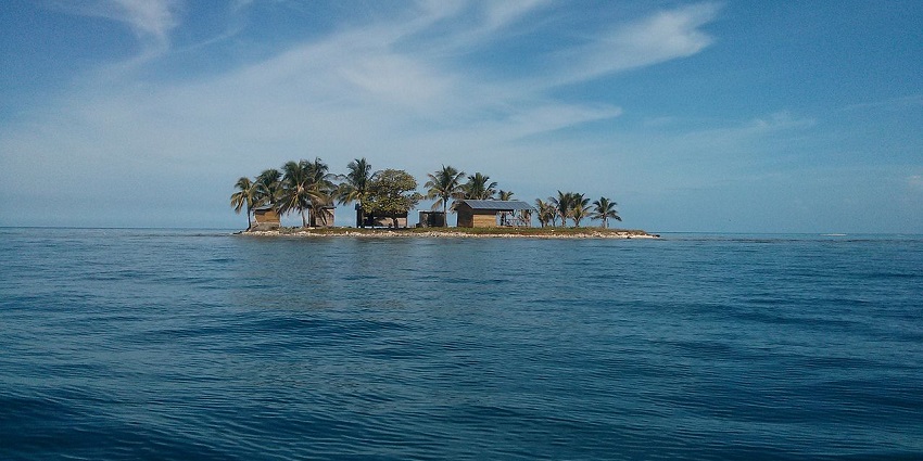 A tiny tropical island surrounded by turquoise waters, showcasing a unique escape amidst nature