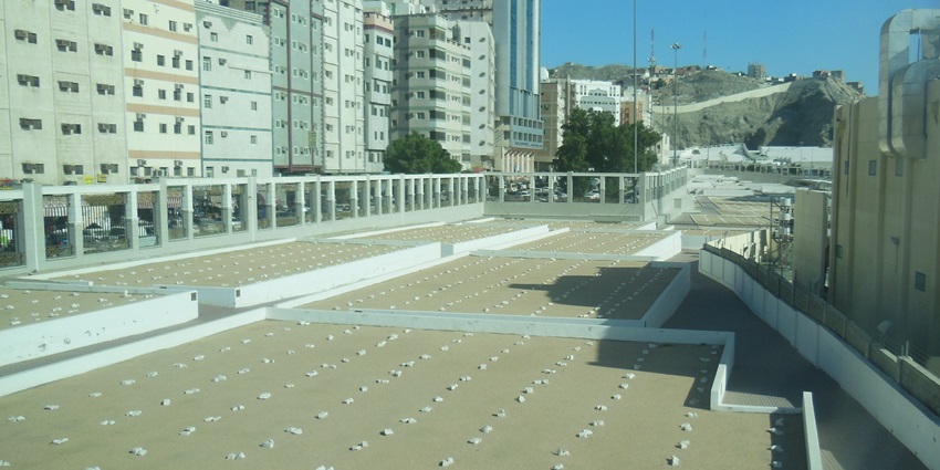 View of the ancient cemetery of Jannat al-Mu’alla surrounded by city buildings.