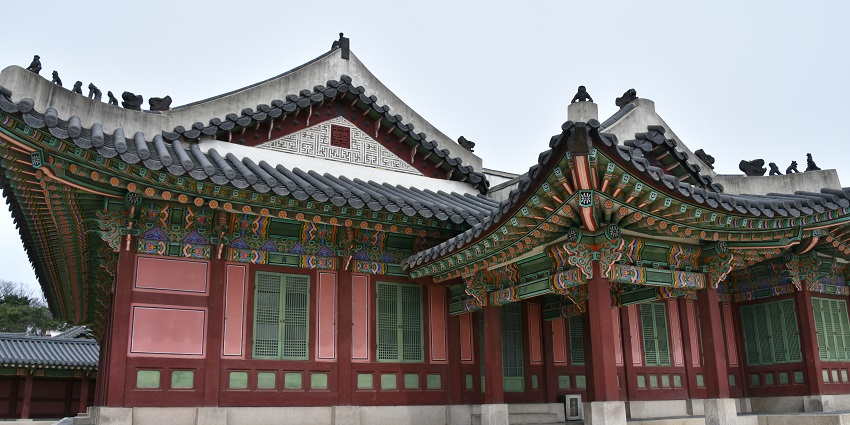 Traditional Korean architecture of Changdeokgung Palace in Seoul, with curved rooftops and wooden buildings, one of the iconic monuments in South Korea.