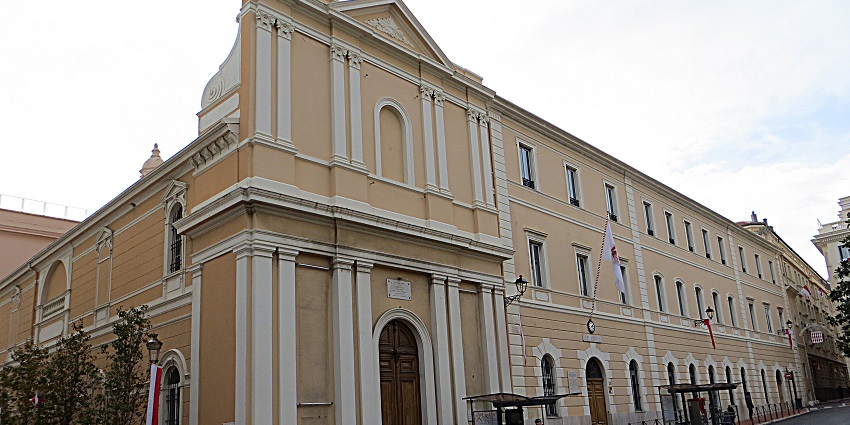 The Chapel of the Visitation with traditional architect, flag and people walking on the sidewalk