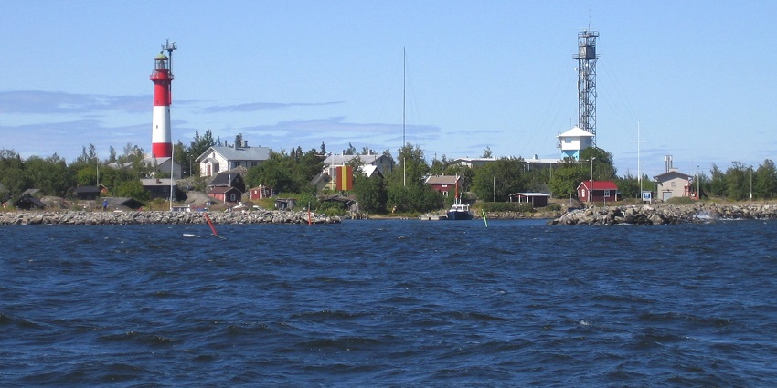 Remote islet with lighthouse views and a chapel amidst vast seascapes.