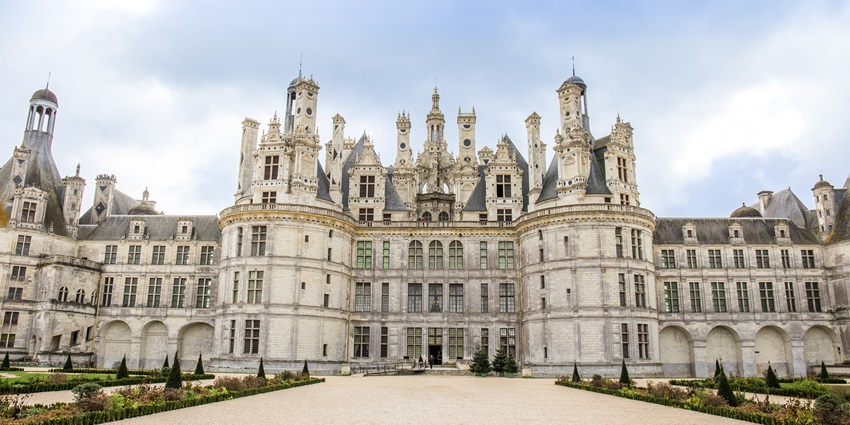 The Chambord Castle, surrounded by dense forest, is one of the monuments in France.