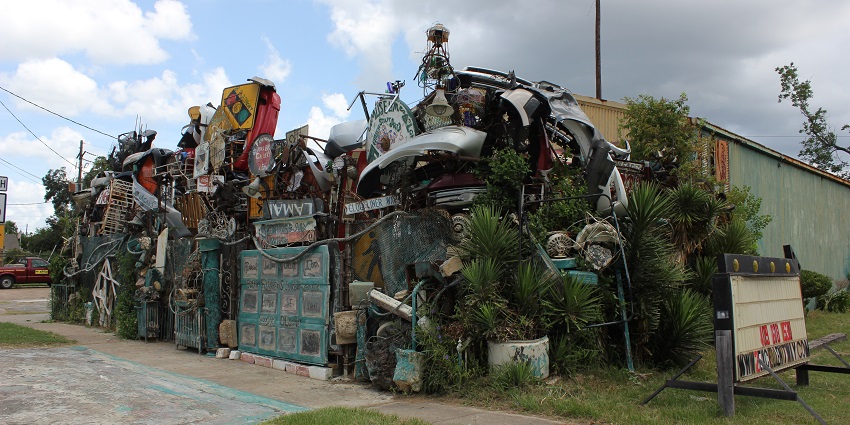 A colorful structure built from junk such as bikes, wires, and toys forming walkable paths and arches is one of the best things to do in Austin