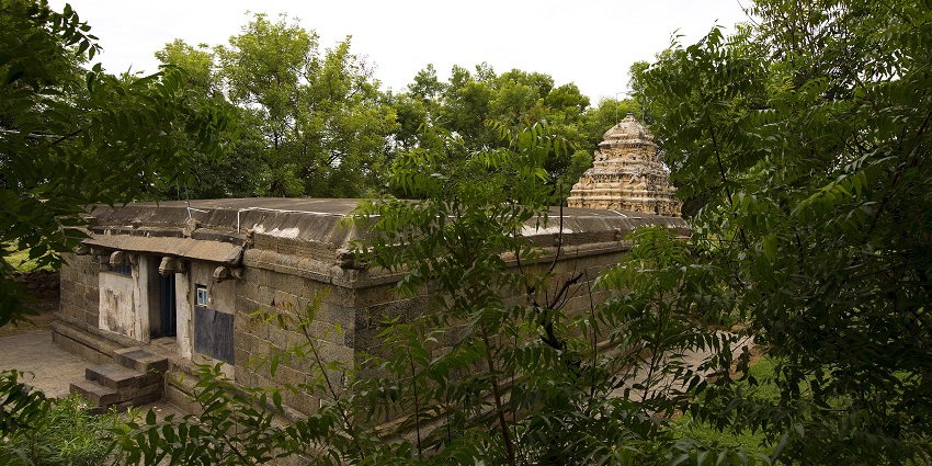 Serene temple complex dedicated to Vishnu with traditional gopuram and scenic surroundings