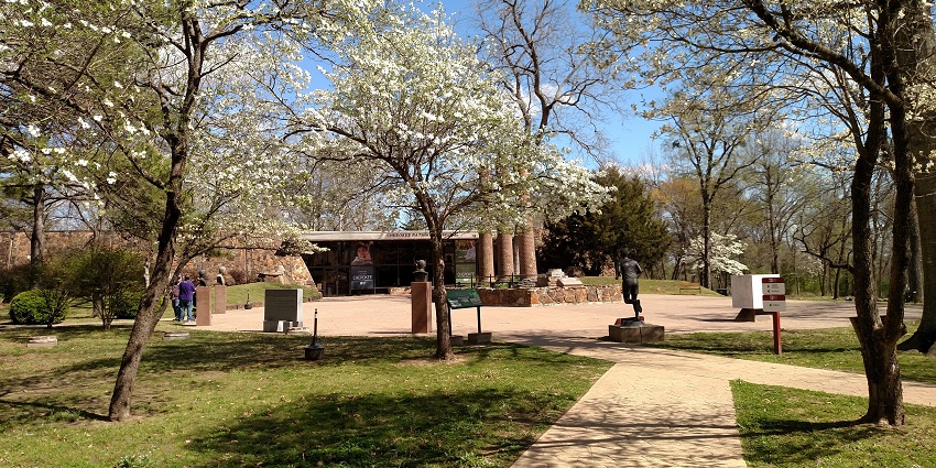 Exterior view of the Cherokee Heritage Center surrounded by trees and open space