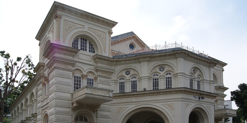 A grand colonial-style building with windows, one of the oldest monuments in Singapore.