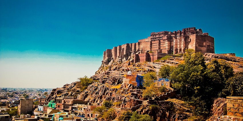 Majestic view of Mehrangarh Fort rising above Jodhpur with intricate stone architecture
