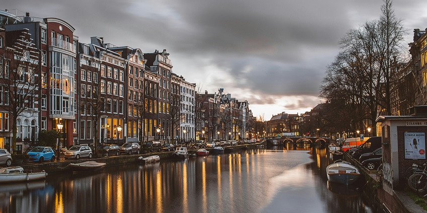 Canals and historic buildings showcasing what Amsterdam is famous for in the town