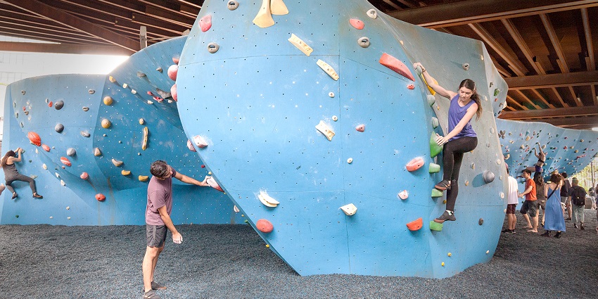 Climbing colorful bouldering walls at the Cliffs at DUMBO in Brooklyn Bridge Park.