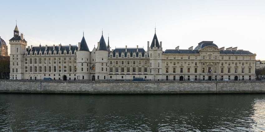 Stone towers of the Conciergerie along the banks of the Seine River, one of the must-see historic places in Paris