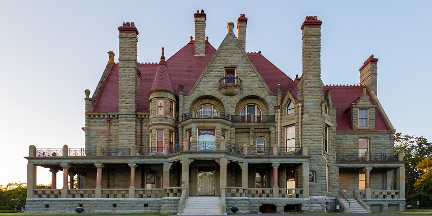 Grand stone mansion with red gabled roofs and ornate architectural details, one of the top historical places in Victoria.