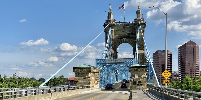 Visiting the iconic blue John A. Roebling Suspension Bridge over the Ohio River, one of the top things to do in Cincinnati.