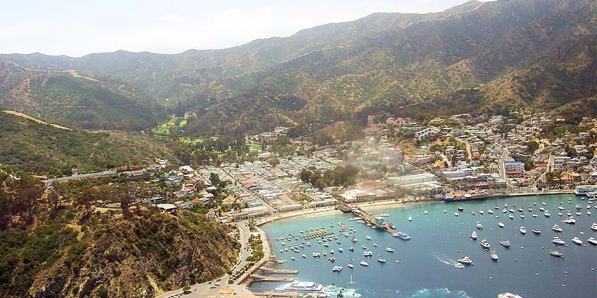 Avalon on Catalina Island with waterfront, colourful buildings, and boats in harbour.