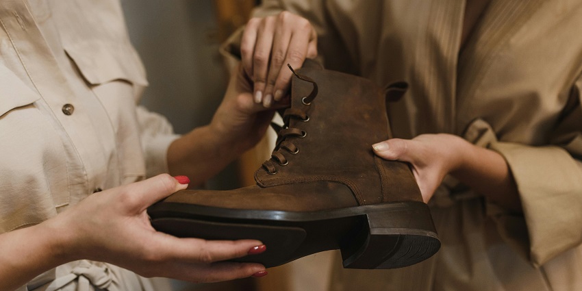 A woman checking a brown leather boot in the Customised Boots store on Music Row in Nashville.
