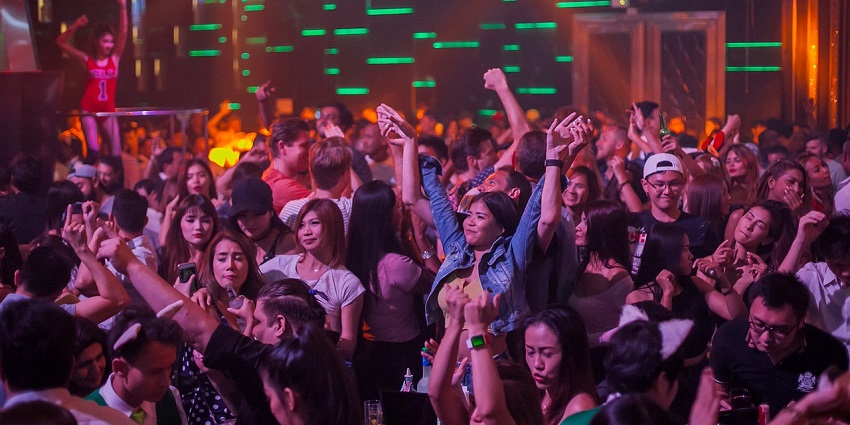 Packed dance floor with lights at the iconic E11EVEN Miami nightclub.

