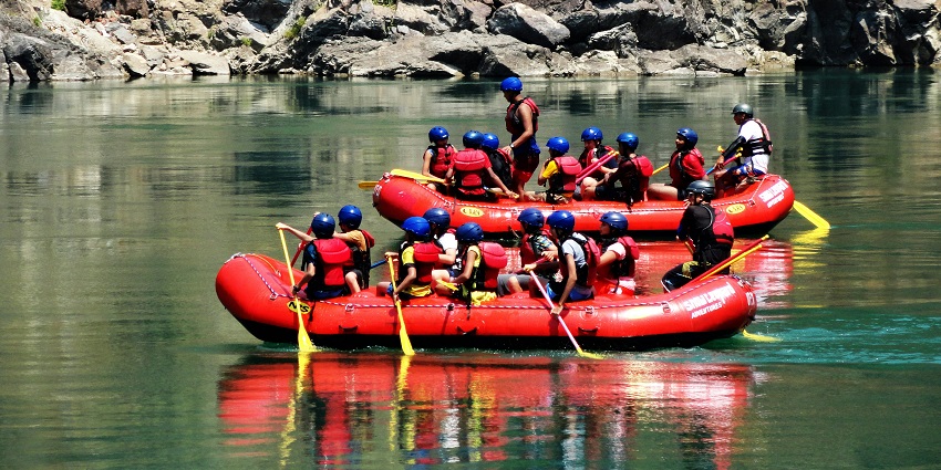 Adventurers enjoying river rafting on the fast-flowing waters of Dandeli River.