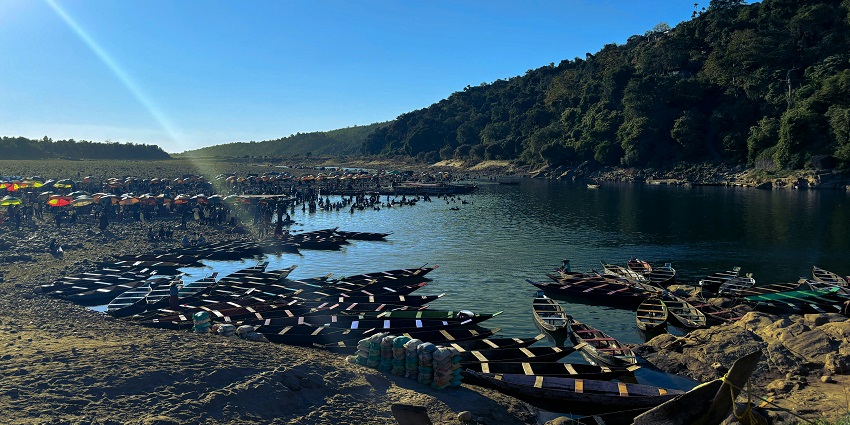 Umngoat River with still water body, perfect reflections of the green mountains and boats.