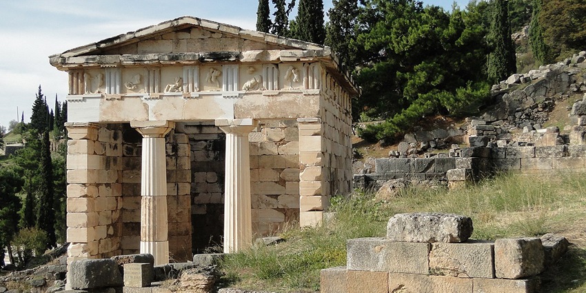 Treasury of the Athenians in Delphi, an ancient Greek temple-like structure with columns, one of the most popular historical places in Greece.