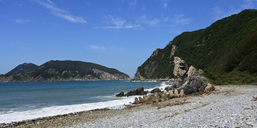 Black-sand beaches and dense pine forests line peaceful Deokjeokdo Island in South Korea.