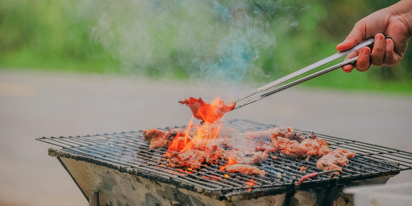 Smoking grills packed with sizzling meat skewers at Mamboz Corner reflect authentic food things to do in Dar es Salaam.
