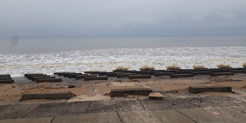 Digha sea beach in West Bengal has gentle waves washing over the wide sandy shore.