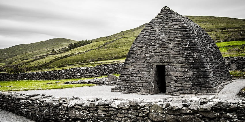 Exploring the ancient stone church with a curved roof set in green fields on the Peninsula, one of the interesting things to do in Dingle.