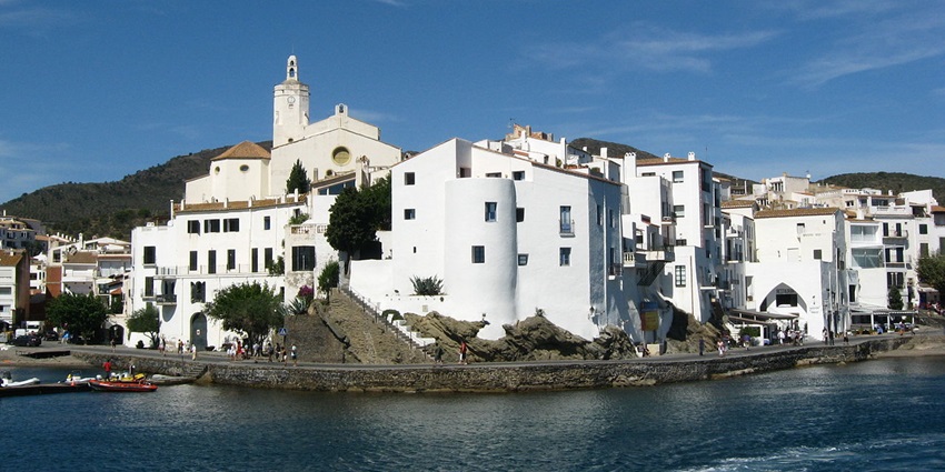 Visiting the Whitewashed buildings and coastal views of Cadaqués, one of the best things to do in Costa Brava.