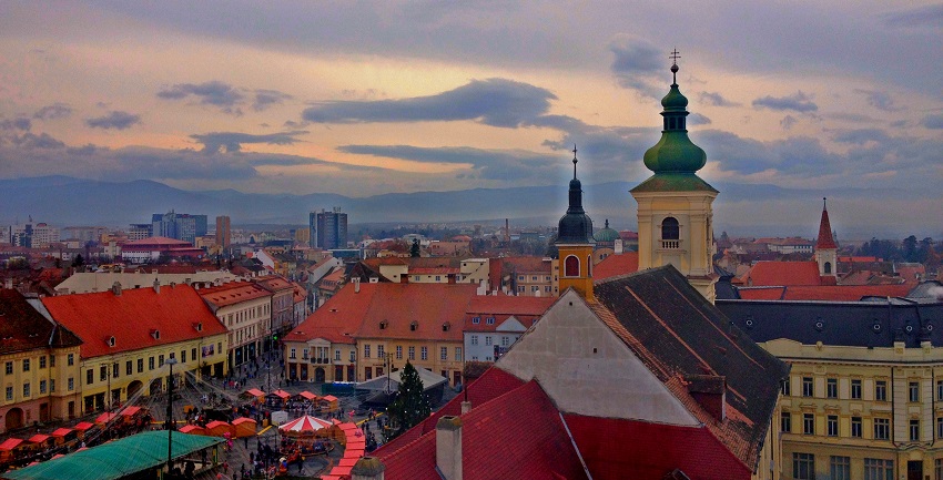 Things to do in Romania include discovering Sibiu’s charming old town with its pastel facades and ‘eyelid’ rooftops.