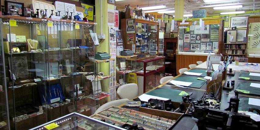 Interior of the Sheaffer Pen Museum with vintage desks, writing instruments, and historical displays.