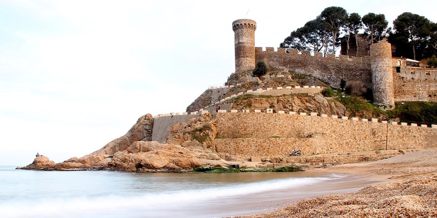 Things to do in Costa Brava include walking along cobbled streets and the ancient stone walls of Tossa de Mar’s medieval old town.