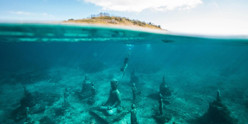Discover enchanting underwater statues at Hideaway Island, a top spot for snorkelers