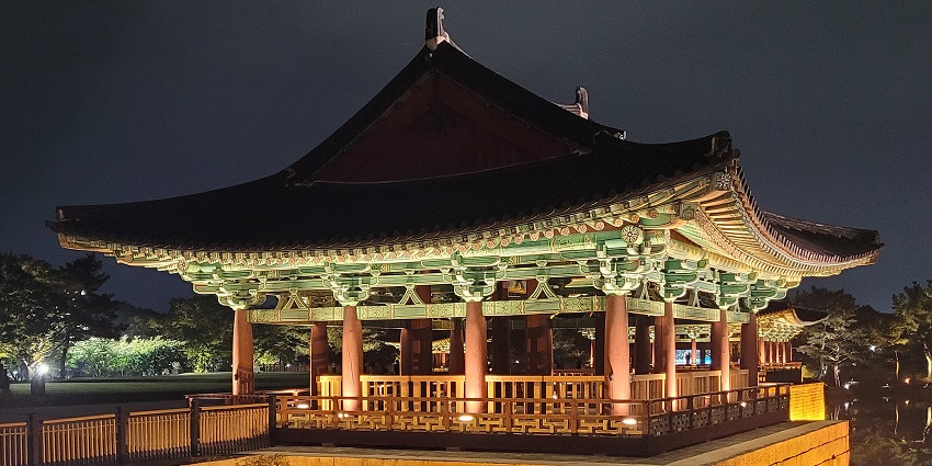 Donggung Palace and Wolji Pond in the back at night with traditional Korean architecture