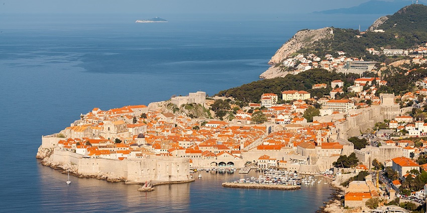 Aerial view of Dubrovnik’s old town with orange rooftops and city walls by the sea, one of the best historical places in Europe.