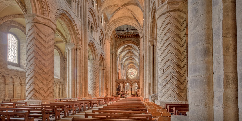 Interior of Durham Cathedral with detailed architecture, unique ceiling and designs on pillars