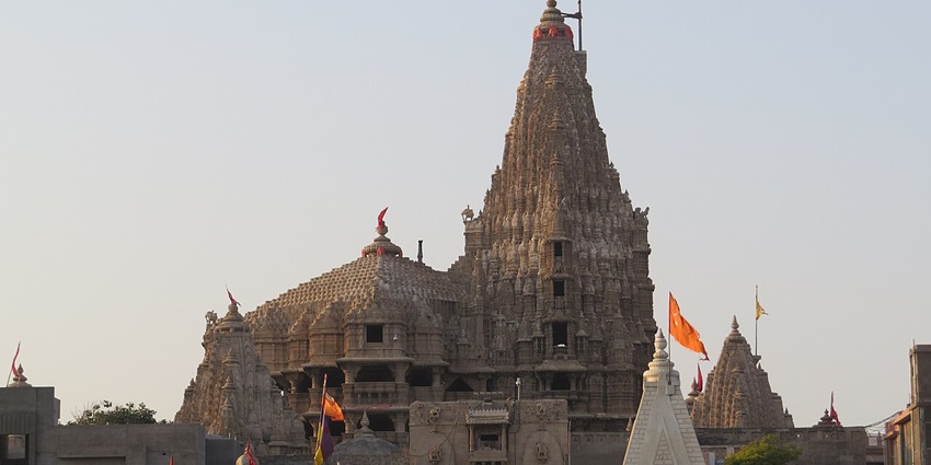 Sacred temple dedicated to Lord Krishna, featuring ornate pillars and pilgrims in colourful attire.