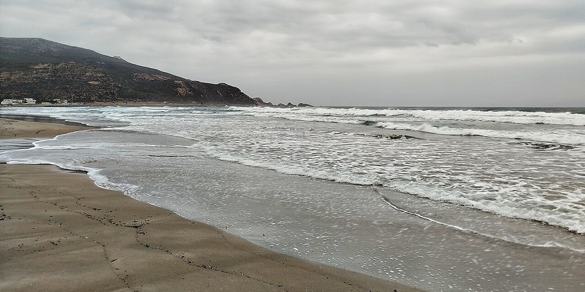 El Haouaria Beach boasts turquoise waters, golden sands, and rugged cliffs along Tunisia’s coastline.