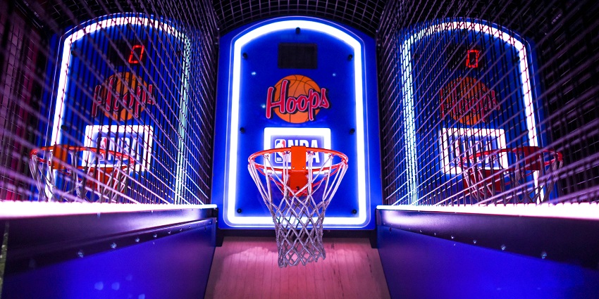 Arcade basketball game glowing under neon lights, offering non-stop fun at Strike Zone.