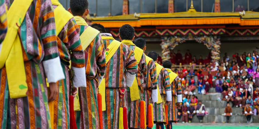 A group of male dancers get ready for a traditional item during Thimphu Tshechu.