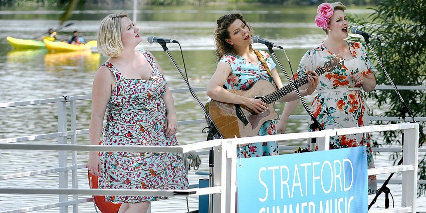 Musicians performing classical music inside a floating barge with skyline views in NY