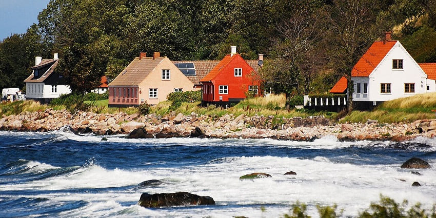 Exploring the remote Baltic island known for round churches, artisan crafts, and rugged sea cliffs, one of the best things to do in Denmark in summer.