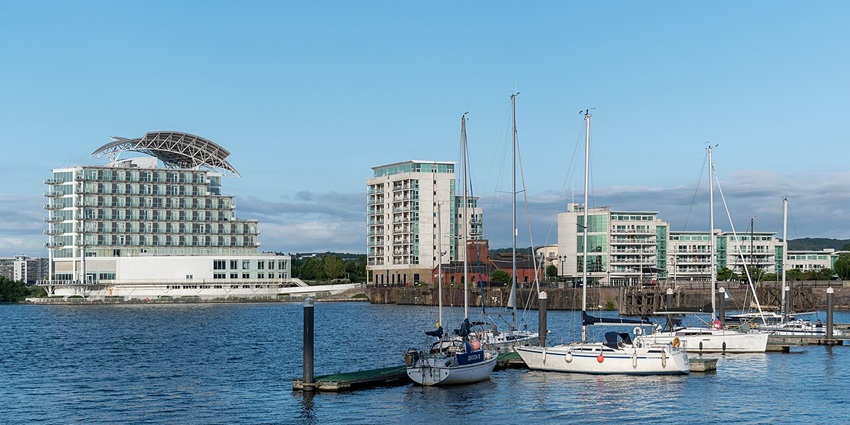 Cardiff Bay waterfront with restaurants, shops, and Wales Millennium Centre, offering vibrant entertainment and dining experiences.